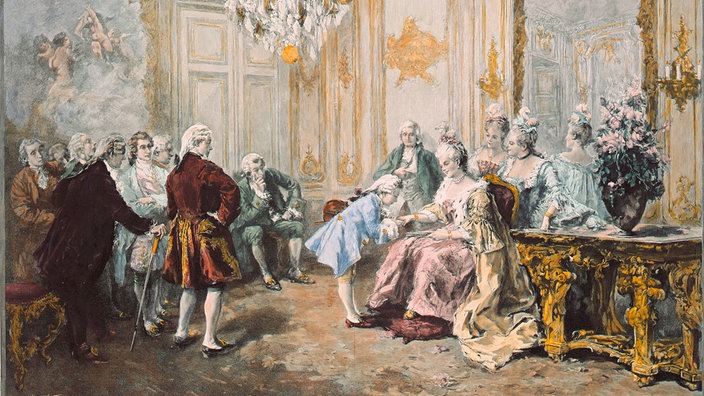 In einem historischen Prunksaal küsst der kleine Mozart die Hand von Madame Pompadour.