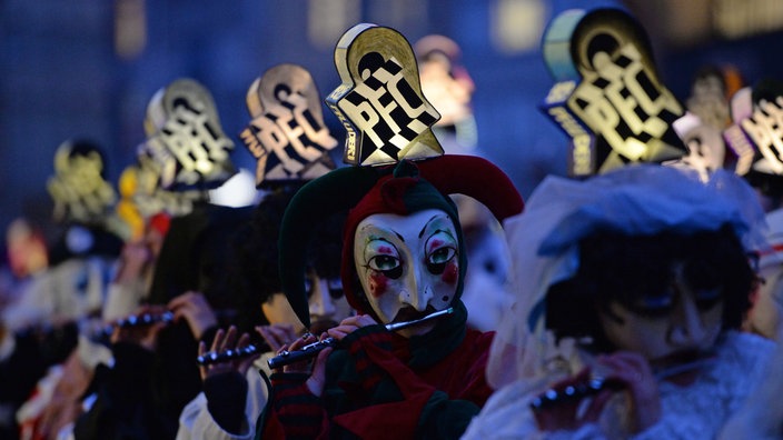 Narren ziehen beim "Morgestraich" musizierend durch die Gassen der Innenstadt von Basel in der Schweiz.